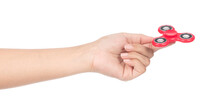 Fingers Playing A Red Fidget Spinner Isolated On A White Background