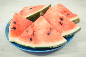 Slice of watermelon on blue plate, concept of healthy delicious dessert