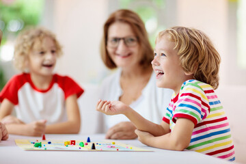 Wall Mural - Family playing board game. Kids play.