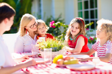 Wall Mural - Family eating outdoor. Garden summer fun.