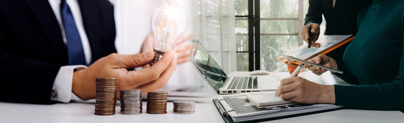 businessman holding coins putting in glass and using calculator. concept saving money and finance accounting.