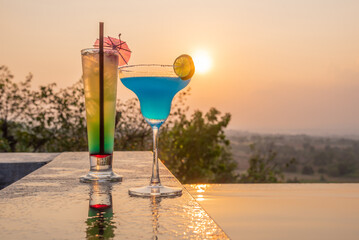 Cocktails near the swimming pool at sunset