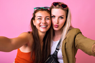 Wall Mural - Two stylish hipster woman, best friends sister girls hugs and smiling