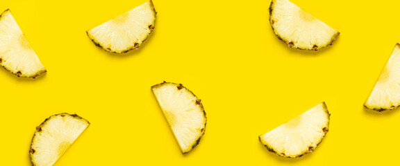 Wall Mural - Pineapple slice against on a yellow background. Top view, flat lay. Banner