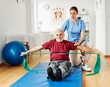 © Lumos sp - nurse doctor senior care exercise physical therapy exercising help assistence retirement home physiotherapy strech band clinic therapist elderly man