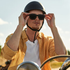 Portrait of young caucasian man in scooter helmet