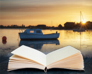Wall Mural - beautiful summer sunset landscape over low tide harbor with moored boats