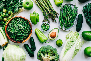 Healthy organic green food, assortment of fresh vegetables: Avocado, lettuce, broccoli, green peas, cucumber, pepper, celery, kale, asparagus and other. Top view