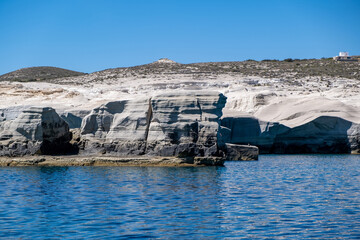 Wall Mural - Sarakiniko beach at Milos island, Cyclades Greece. White rock formations, cliffs and caves over blue sea