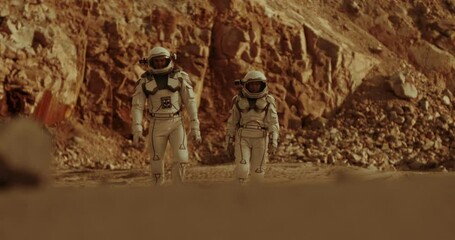 male and female cosmonauts walking on mars
