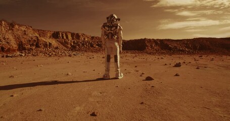 Wall Mural - Anonymous astronauts standing on arid terrain of Mars
