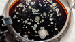 Fungus, moldy food, moldy coffee drink top view. Black coffee is covered with fungus