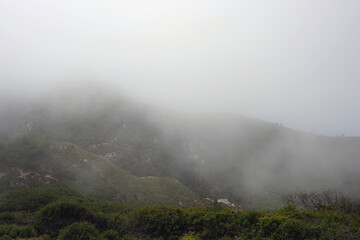 Wall Mural - Central California coastal mountains with fog coming in from the ocean on an early summer day