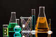 © Tetra Images - Laboratory glassware with liquids against black background