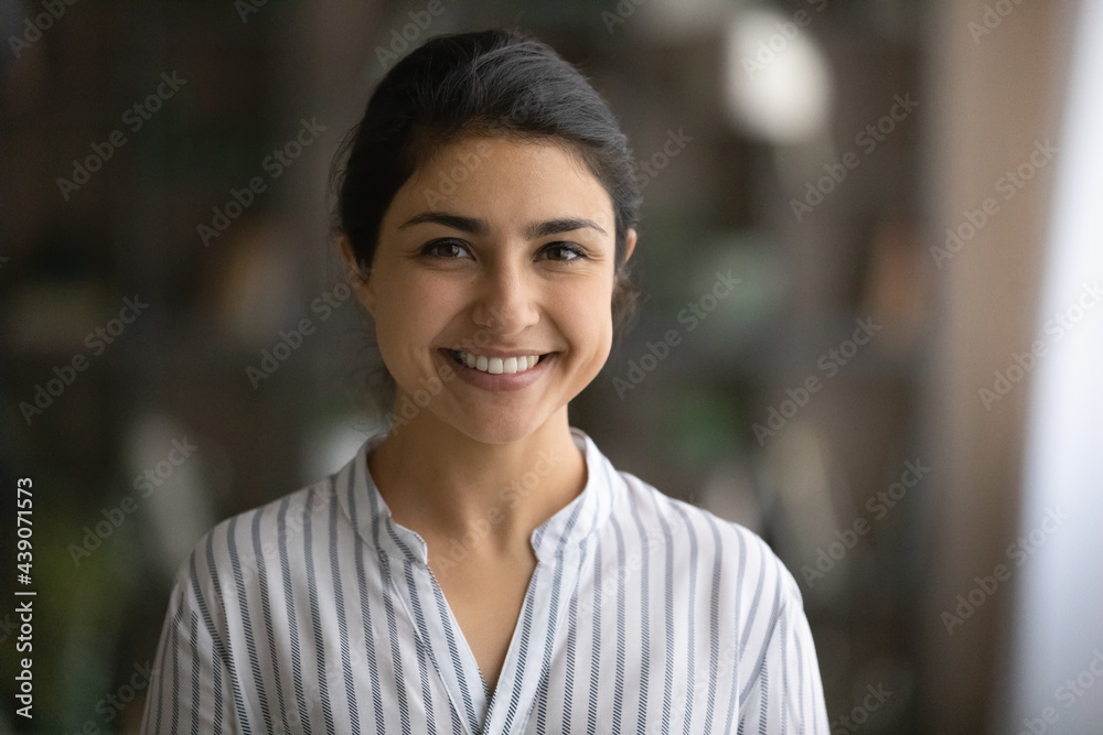 Profile picture of cheerful young female businesswoman student posing indoors. Headshot portrait of friendly casual indian lady office employee consultant look at camera able to help assist customer - obrazy, fototapety, plakaty 