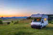 © fabio lamanna - Sunset clear sky over camper van in Montelago highlands, Marche, Italy. Traveling road trip in unique hills and mountains landscape, alternative vanlife vacation concept.