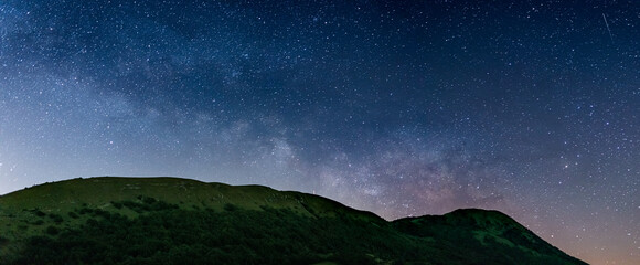 Wall Mural - panoramic night sky over montelago highlands, marche, italy. the milky way galaxy arc and stars risi