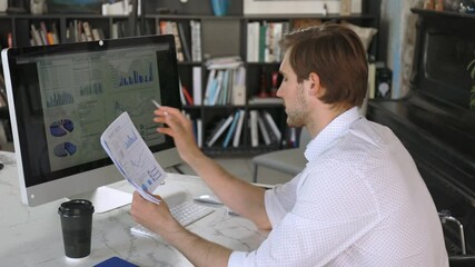 Sticker - Young modern business man analyzing data using computer while working in the office.