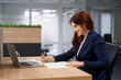 © diignat - Portrait of businesswoman with laptop writes on a document at her office.