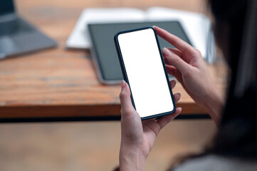 Wall Mural - cropped shot of woman hands holding blank screen smartphone with copy space.