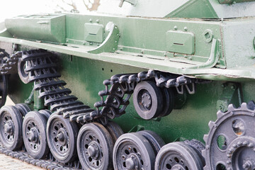 Fragment of a tracked track on green camouflage tank.