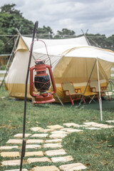 hanging lantern with stand beside stone walking way at camp