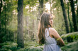 © NatBud - Happy girl in the summer village . Girl in a white dress among the ferns.  Girl and fern. Girl  in a dress and white hat among a green park in the morning