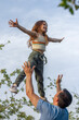 © Daria - Father throwing young girl up into the air