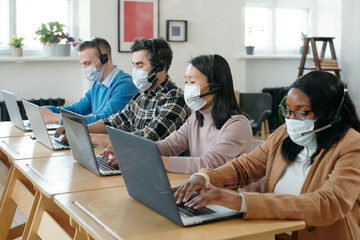 Poster - Busy technical specialists using laptops
