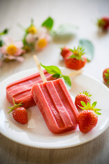 Poster - homemade strawberry ice cream on a stick made from fresh strawberries in a plate