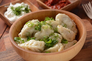 Homemade dumplings, Dagestan cuisine, Kurze. Dumplings kurze with meet filling, and adjika hot sauce  on a plate