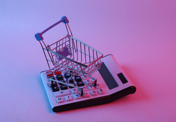 Calculator with shopping trolley in pink blue gradient neon light