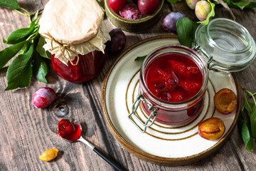 Wall Mural - Homemade preservation. Delicious plum jam on a rustic wooden table.