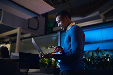 One manager works on laptop in night office