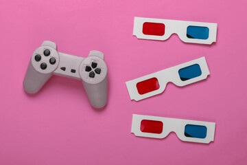 Wall Mural - Anaglyph disposable paper 3d glasses and retro gamepad on pink background. 3d video games. Top view