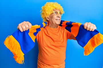 Poster - Senior hispanic man football hooligan cheering game smiling looking to the side and staring away thinking.