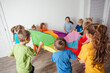 © oksix - Children stretching colorful parachute for fun team games