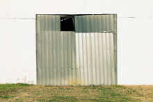 White Steel Corrugated Metal Siding Farm Warehouse Building Facade With Weathered Aged Broken Sliding Doors