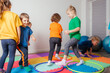 © oksix - Sport activities with hula hoops at kindergarten