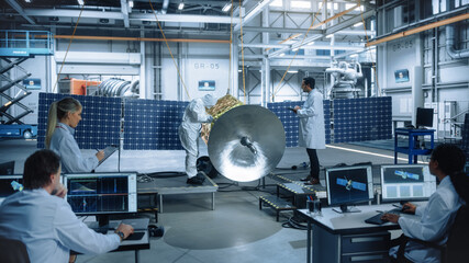 Wall Mural - Team of Engineers Working on Satellite Construction. Aerospace Agency Spaceship Manufacturing Factory: Diverse Group of Multi-Ethnic Scientists Developing Spacecraft for International Space Program