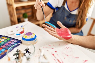 Poster - Couple painting hands at art studio.