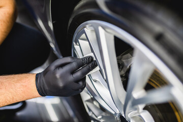 Wall Mural - A man cleaning car, car detailing (or valeting) concept. Selective focus..