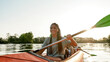 © Svitlana - Active young woman smiling, enjoying a day kayaking together with her boyfriend in a lake on a late summer afternoon