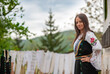© Milos - A young woman is posing in a traditional Serbian handmade outfit Litak (narodna nošnja Litak)