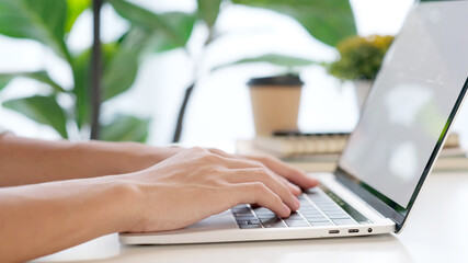 Wall Mural - close up of man hand typing laptop computer while working at home office, student college online stu