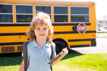 Aufkleber - Back to school. Happy child near school bus. Cute school boy potrait.