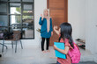 © Odua Images - happy kid wave goodbye to mother before going to school in the morning