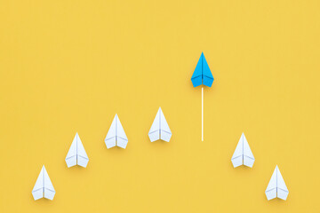 Wall Mural - Business concept for new ideas creativity, innovative solution and Leadership concept with blue paper plane leading among white on yellow background