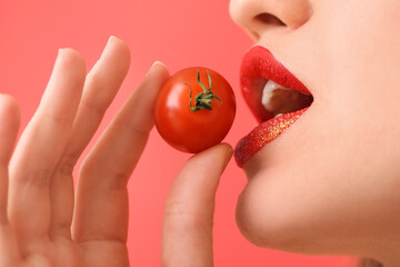 Wall Mural - Beautiful young woman with cherry tomato, closeup