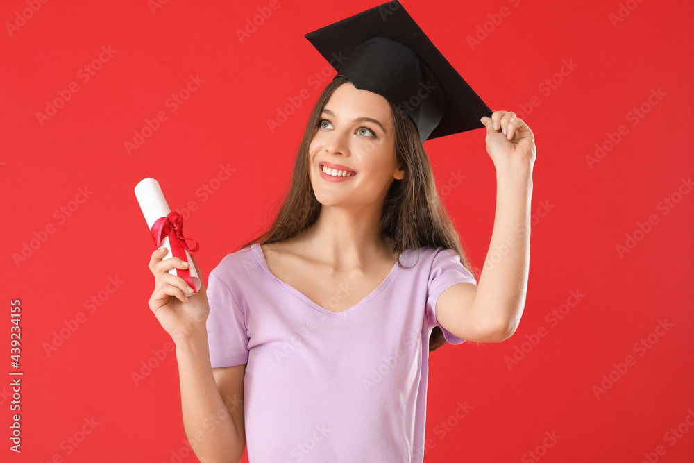 Happy female graduating student with diploma on color background